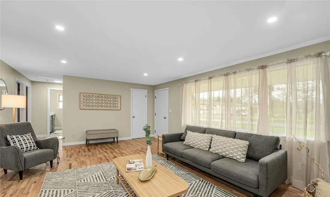 Living room with warm oak hardwood floors after a whole-home remodel in Kent