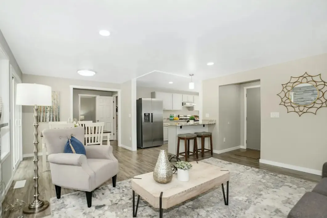 Open living room and kitchen with gray luxury vinyl plank flooring throughout